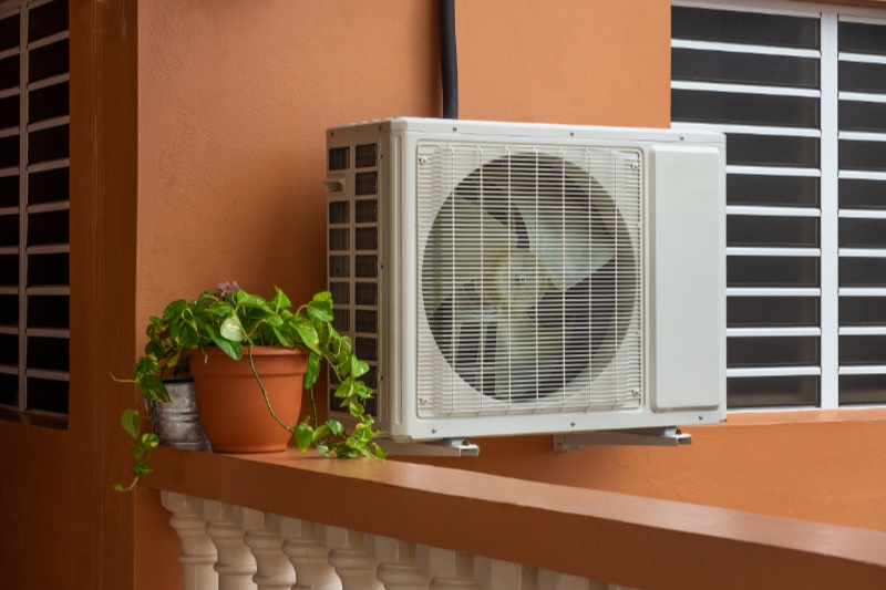 Air Conditioners Versus Heat Pumps. Air conditioning unit outside a house.
