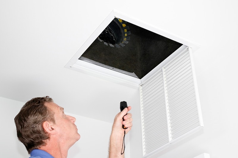 Man Inspecting HVAC